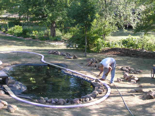 [Foam roadbed laid around pond]
